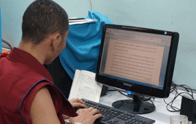 staff typing dharma texts